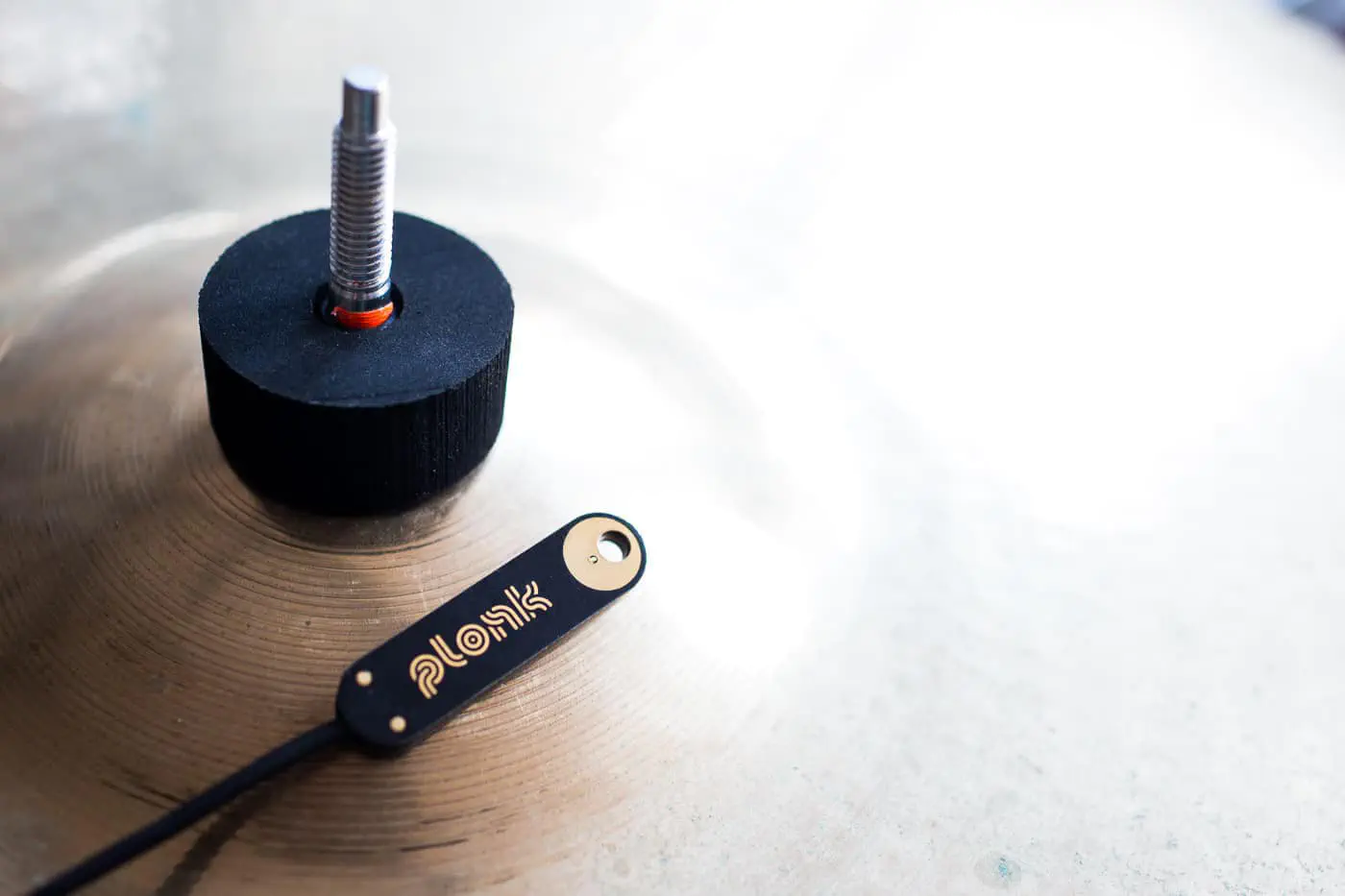 PLONK® struktophon attached to a cymbal. You might want to add some pressure to the sensor element: the more pressure you apply (within reason), the more direct will be the transmission of vibrations to the sensor.